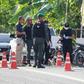 Police inspect the scene of a deadly attack by suspected rebels at a military outpost in Pattani, southern Thailand.