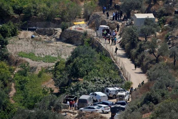 Israeli ambulance crews and security forces deploy to the scene of an explosion near the Israeli settlement of Dolev in the occupied West Bank
