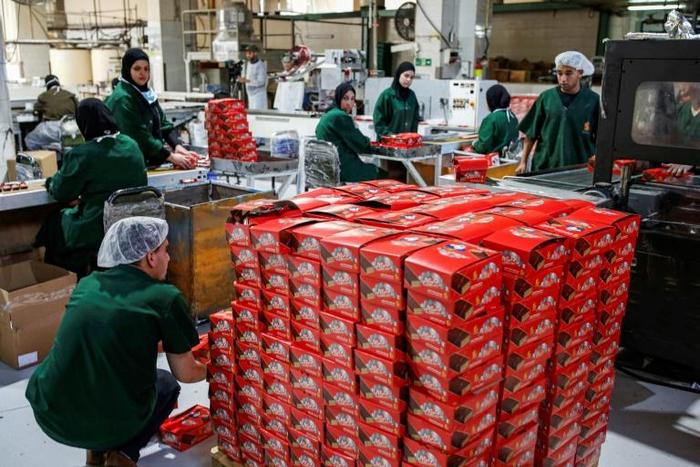Boxes of unsold biscuits are piled up in a West Bank warehouse, a sign of tough economic times faced by Palestinians