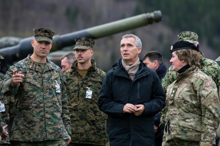 Stoltenberg (pictured centre at a military exercise) insisted that NATO did not want an 'arms race'