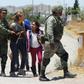 Mexican National Guardsmen detain Central American migrants trying to cross the Rio Bravo, in Ciudad Juarez on June 21, 2019