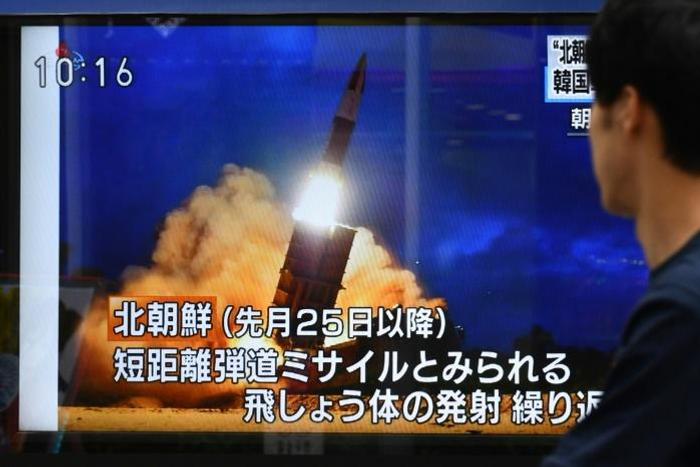 A pedestrian in Tokyo watches a television report on the latest North Korean launch