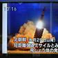 A pedestrian in Tokyo watches a television report on the latest North Korean launch