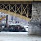 A picture taken on June 7, 2019 shows teams of experts and divers on boats on the Danube under the Margit Bridge during the operations to hoist the submerged boat following a boat accident in Budapest