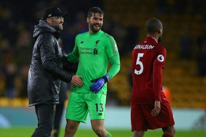 Get Becker soon: Jurgen Klopp (left) is hoping for a speedy recovery for Alisson Becker (right)