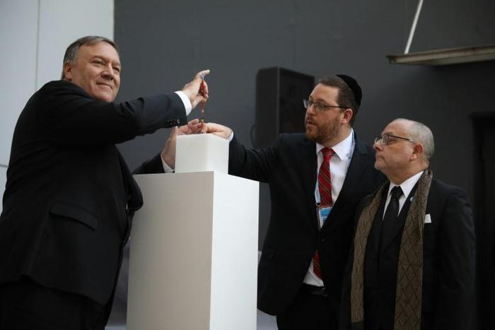 US Secretary of State Mike Pompeo lights a candle next to Argentine Foreign Minister Jorge Faurie and the president of the Asociacion Mutual Israelita Argentina (AMIA) Ariel Eichbaum to pay homage to the victims of a bombing at the center which left 85...