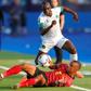 Angola's defender Bruno Gaspar (bottom) vies for the ball with Mauritania's midfielder Khassa Camara during the 2019 Africa Cup of Nations (CAN) Group E football match between Mauritania and Angola at the Suez Stadium on June 29, 2019.