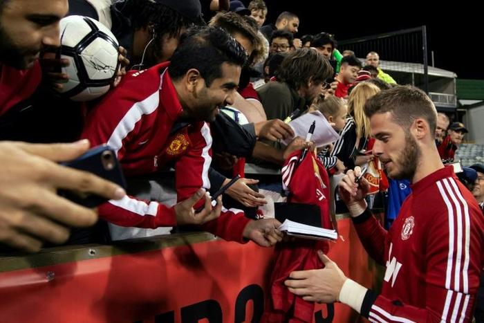 New deal? Manchester United goalkeeper David De Gea signs autographs for fans in Perth