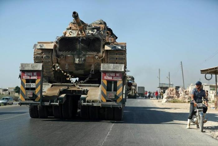 A convoy of Turkish military vehicles passes through the town of Saraqeb in Idlib province on August 19, 2019