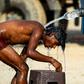 An Indian truck driver takes a cooling bath in Allahabad, where temperatures have neared 50 degrees Celsius (122 Fahrenheit)