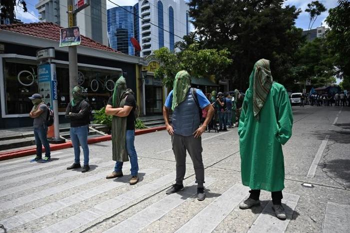 Activists block a street in Guatemala City to protest against a migration agreement signed with the US