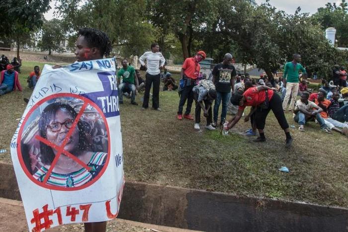 A protester in July carries a banner calling for the ousting of Malawi Electoral Commission chairwoman Jane Ansah