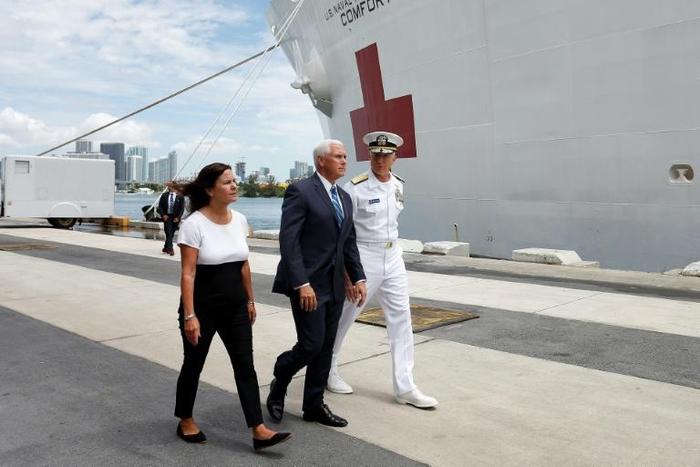 Karen Pence (L), Vice President Mike Pence (C) and Southern Command Admiral Craig Faller (R) walk past the US Naval Hospital Ship Comfort at the Port of Miami