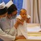 Nurses hold a baby at a birth center in Beijing in December 2016