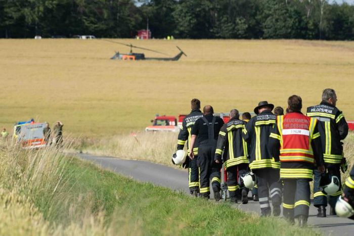 Firefighters head to the site where an army helicopter crashed in Aerzen, northern Germany, killing the pilot July 1, 2019