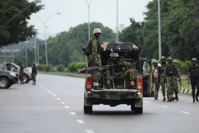 Soldiers aboard a truck patrol during a violent protest by Shiite Muslims demanding the release of their detained leader Ibrahim Zakzaky on July 23, 2019 in Abuja. At least eight people were killed in clashes between Shiite Muslim protesters and Nigeri...