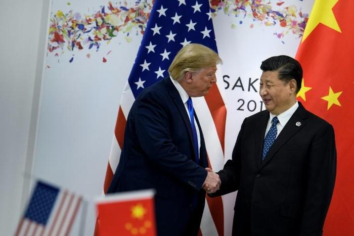 US officials will soon resume face-to-face trade talks in China, a White House official has said, reviving negotiations that had verged on collapse in May; in this image Xi Jinping (R) greets US President Donald Trump before a bilateral meeting on the ...