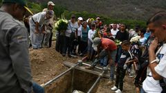 Relatives and friends of Erick Altuve attend his funeral