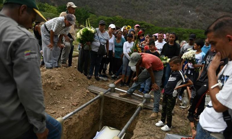Relatives and friends of Erick Altuve attend his funeral