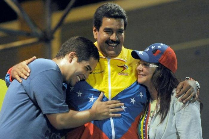 In this 2013 photo, Venezuelan acting President Nicolas Maduro (C) embraces his wife Cilia Flores (R) and son Nicolas Maduro during a campaign rally -- Maduro's son is now the target of US economic sanctions