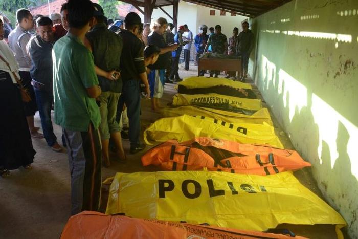 The overloaded passenger boat was carrying more than 60 people when it overturned in rough seas near Madura island
