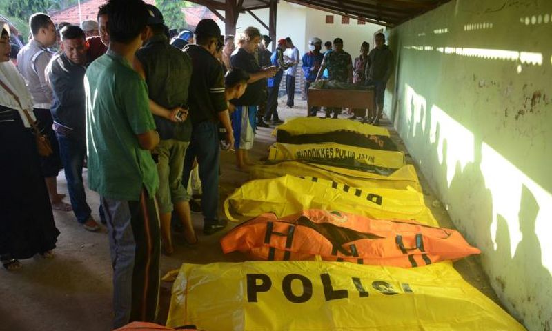 The overloaded passenger boat was carrying more than 60 people when it overturned in rough seas near Madura island