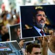 People hold picture of Egyptian President Mohamed Morsi during a symbolic funeral cerenomy on June 18, 2019 at Fatih mosque in Istanbul