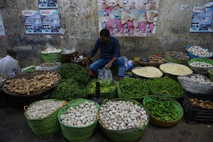 A Pakistan shopkeeper arranges vegetables in his shop at a market in Karachi in June 2019