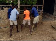 Pupils mould blocks with mud to construct their classroom