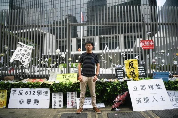 Hong Kong democracy activist Joshua Wong poses during an interview with AFP outside the government headquarters