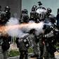 Riot police used tear gas throughout the afternoon and evening in Yuen Long after tense standoffs with protesters, some of whom were throwing projectiles and had surrounded a police van