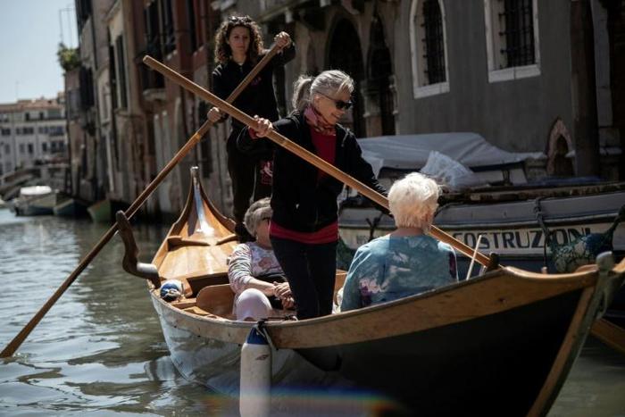The Row Venice organisation is a group of women who teach tourists how to row Venetian style, standing up