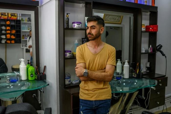 Ahmad Yassine in his Istanbul barbershop where he watched as a crowd attacked his and other Syrian-owned businesses