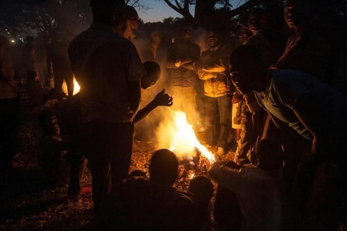 Protesters stand around a fire at a vigil against the result of the May 21 presidential vote in Lilongwe on July 4, 2019. Malawi's re-elected President Peter Mutharika has condemned the protests