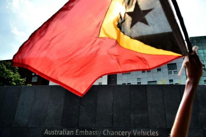 An East Timorese student waves his national flag during a 2016 protest about Australia's intentions in the Timor Sea