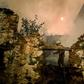 A National Guard firefighter helps battle a wildfire in the village of Roda in central Portugal on July 21
