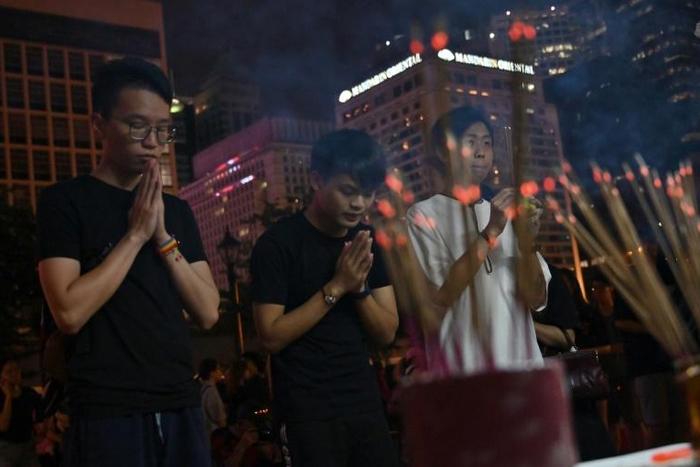 Prayers during a vigil for young people who have killed themselves in recent weeks in Hong Kong
