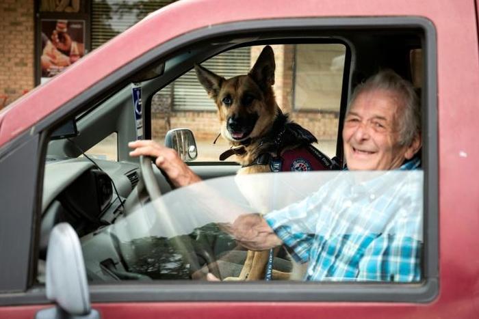 US military veteran Michael Kidd and his companion dog Millie leave after a training session at the Paws of War office in Nesconset, New York -- Millie helps Kidd navigate the difficulties of post-traumatic stress disorder
