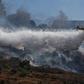 A plane extinguishes a fire in the Jerusalem area on July 18, 2019