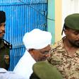 Ousted Sudanese leader Omar al-Bashir being escorted to hear charges of corruption against him in Khartoum: the Internatinal Criminal Court has called for him to face trial for genocide in Darfur