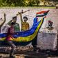 A Sudanese protester runs past a mural during a demonstration near army headquarters in the capital Khartoum back in April