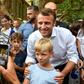 French President Emmanuel Macron (C) on Saturday posed for pictures in Bormes-les-Mimosas, near the fort of Bregancon where he will host his Russian counterpart Vladimir Putin in August