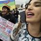 Protesters carry the Algerian flag (L) and the Berber colours side by side at a rally in March against veteran president Abdelaziz Bouteflika in the city of Bejaia east of the capital Algiers