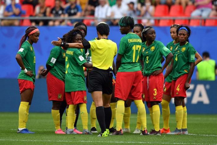 Chinese referee Qin Liang awards one of the goals much to the dismay of the Cameroon team
