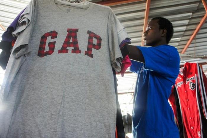 Mind the GAP: Mamadou Sarr prepares his stall at Colobane Market, the biggest trading arena for second-hand clothes in Dakar