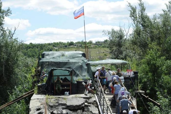 At Stanytsya Luganska, about 11,000 people cross between Ukrainian territory and the Lugansk People's Republic (LPR) every day via a bridge partially destroyed in 2015