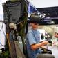 Dozens of young gamers visited Germany's army stall to test out a helicopter simulator