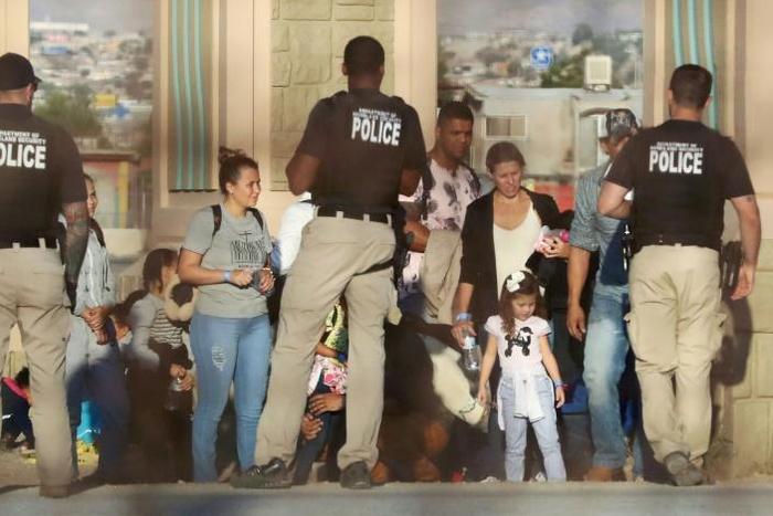 Migrants being detained by Department of Homeland Security officials in June 2019 after crossing into the United States from Mexico: a new rule announced by the White House Monday says most migrants will be automatically ineligble for asylum