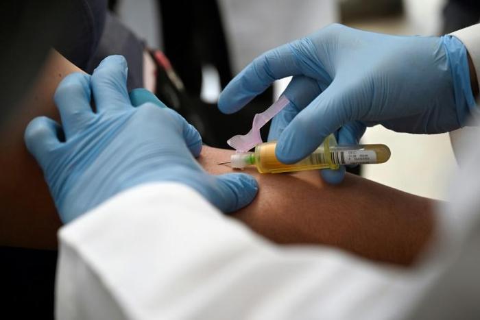 A technician extracts blood from a patient for an HIV test at the specialized Condesa Clinic in Mexico City on July 18, 2019, three days before the opening in the city of an international conference on HIV science