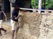 Pupils mould blocks with mud to construct classroom